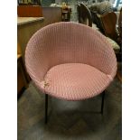 A pink Lloyd Loom bedroom chair