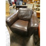 A modern easy chair in chocolate brown leather