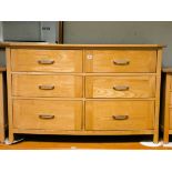 A good quality heavy, light oak, bow front chest fitted six drawers with stainless steel handles,