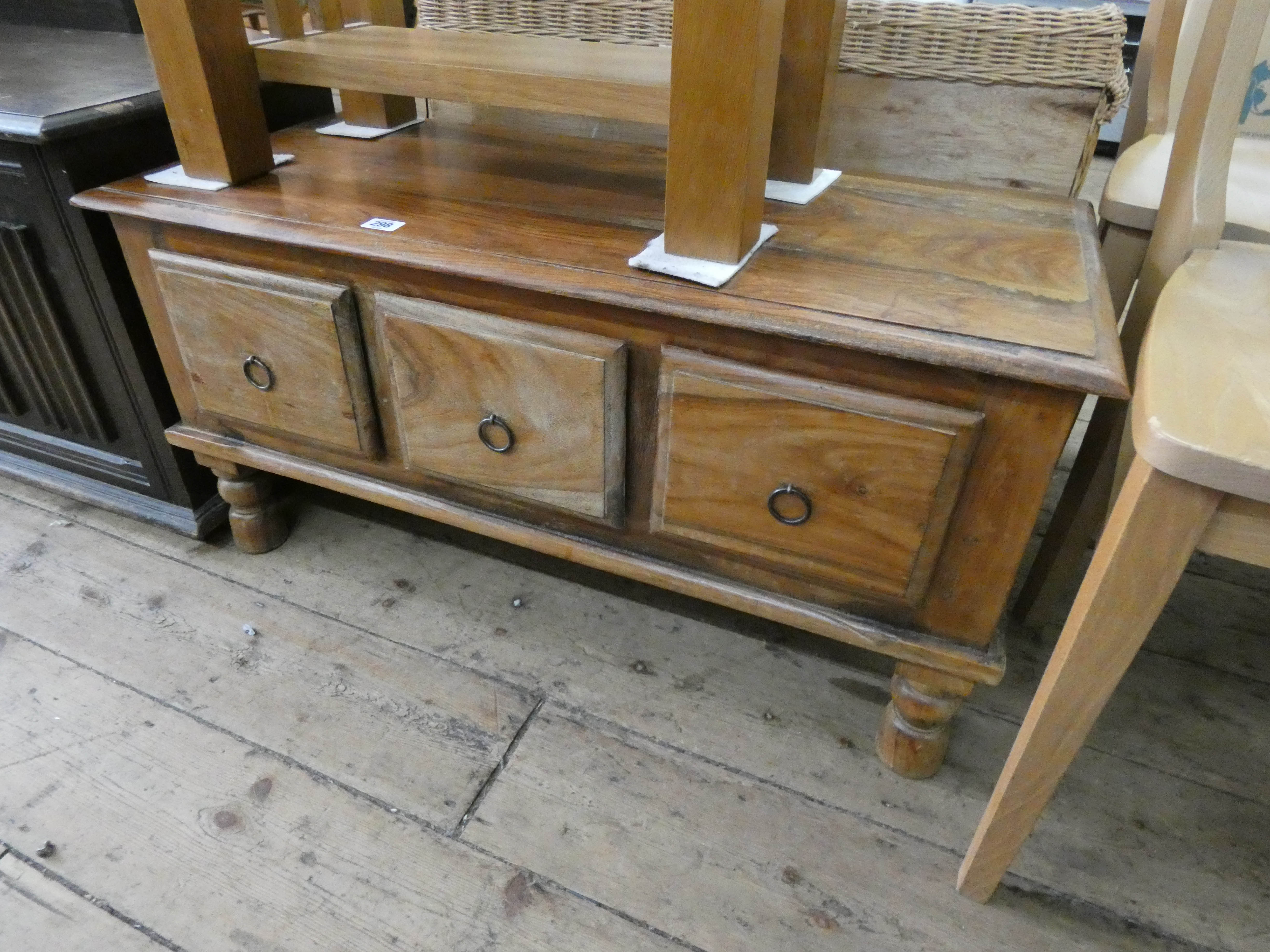 An Indonesian low hardwood television stand fitted three drawers under