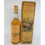 A bottle of 10 year old Glenmorangie single highland malt scotch whisky with presentation tin