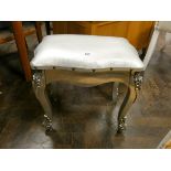 A silver painted dressing stool with upholstered seat