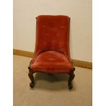 A Victorian walnut framed occasional chair standing on cabriole legs upholstered in pink dralon