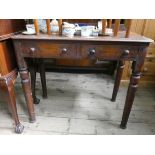 A mahogany side table fitted two drawers on turned legs 35" wide