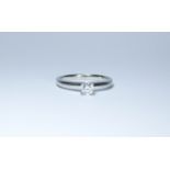 An 18ct round brilliant cut diamond solitaire ring in a four claw setting,