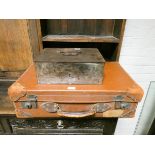 A metal strong box and a leather fibre suitcase