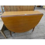 A narrow modern teak oval drop leaf dining table 3' wide