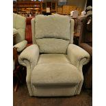 A manual reclining easy chair in pale green covering