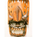 A large carved wooden tribal mask,