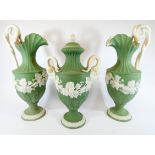 A three piece green Jasper mantelpiece garniture comprising a pair of ewer's and a lidded Neo