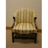 A small Georgian style mahogany framed wing backed elbow chair with cream striped covering