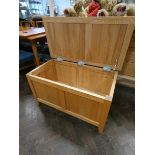 A heavy light oak finished blanket chest,