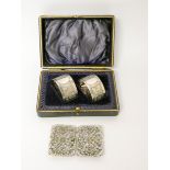 A pair of silver plated napkin rings in case together with a silver plated nurses buckle