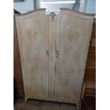 A limed oak two door wardrobe 4' wide