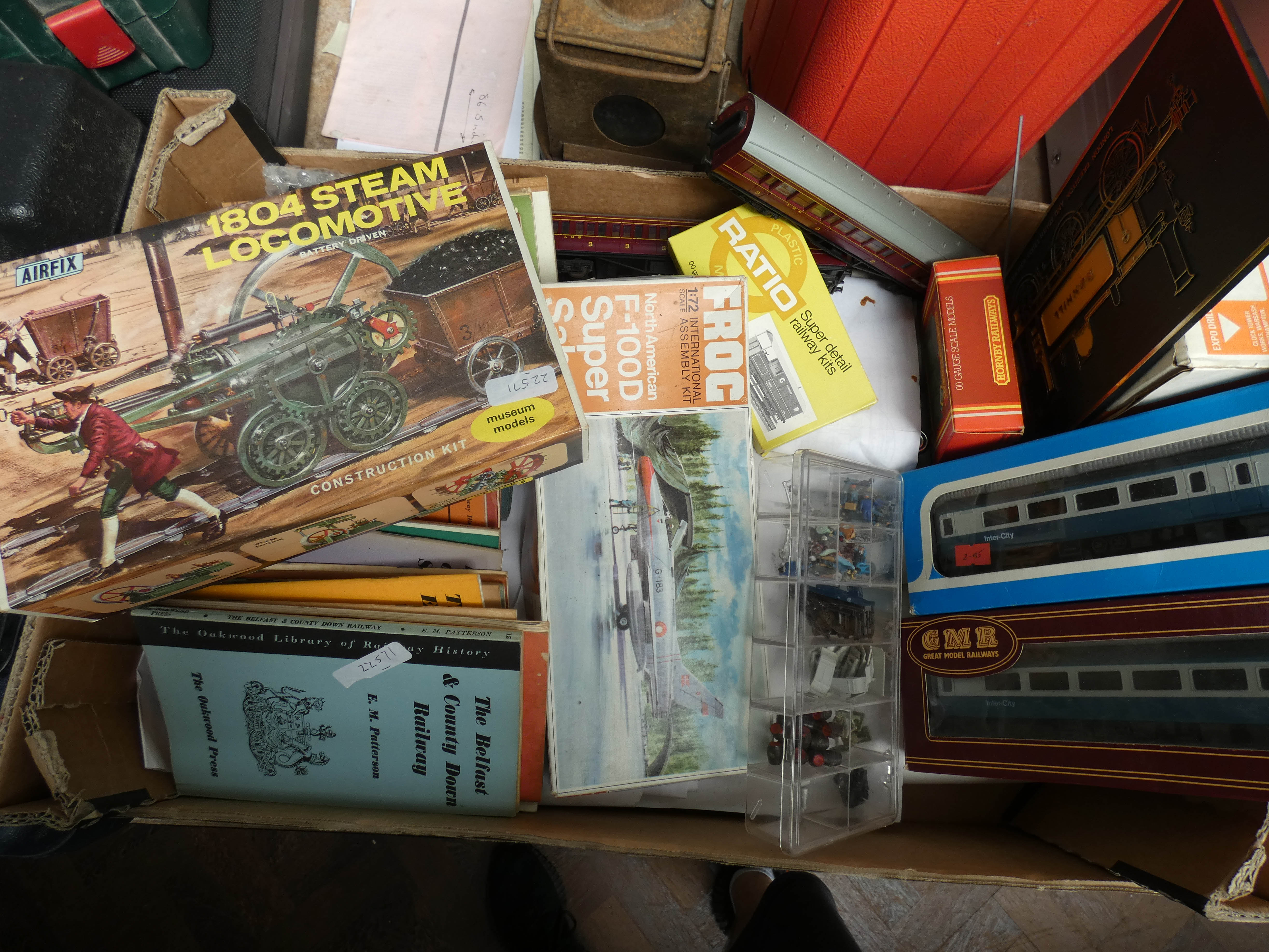 A large box of mostly plastic railway carriages, railway books,