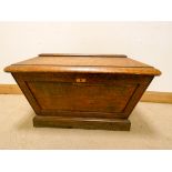 A large Victorian oak sarcophagus shaped wine cooler with zinc liner,