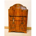 A 1930's Art Deco walnut bureau with cloud shaped top and three drawers under,