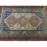 A blue and patterned wool pile Persian rug,