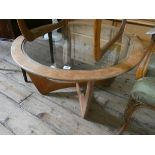 A circular GPlan style teak coffee table with inset glass top 32" diameter