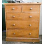 A Victorian style light oak chest of three long and two short drawers with bun handles,