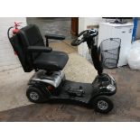 A black Kymco Super 4 mobility scooter,