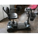 A Travelux Tiempo Rapide black and stainless steel finish four wheel mobility scooter in good