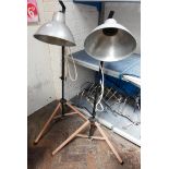 Two tripod base adjustable spot lights with stainless sleet shades