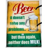 A painted metal advertising sign 'Beer doesn't solve any problems but then again neither does milk',