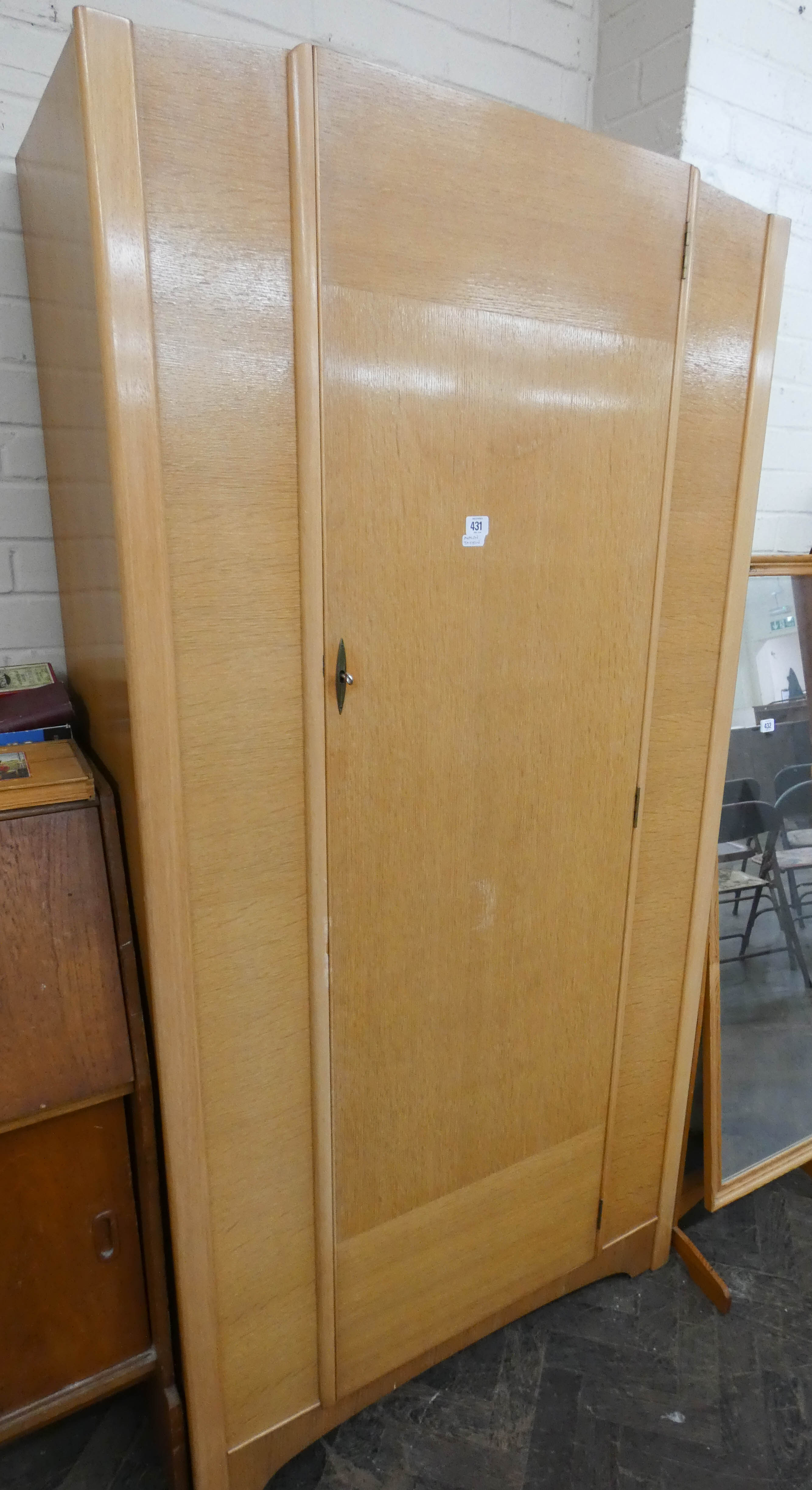 A modern light oak single door wardrobe,