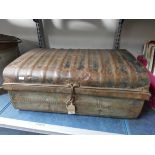 A small old partly rusted metal trunk