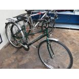 A green Raleigh Pioneer Classic ladies bicycle with rear rack