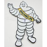 A cast iron wall hanging waving Michelin man sign,