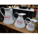 Three white Esso jugs