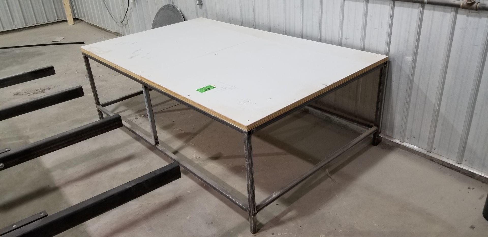 Steel table with pressboard top 5' x 8'// Table en acier avec plateau en carton comprimé 5' x 8'.