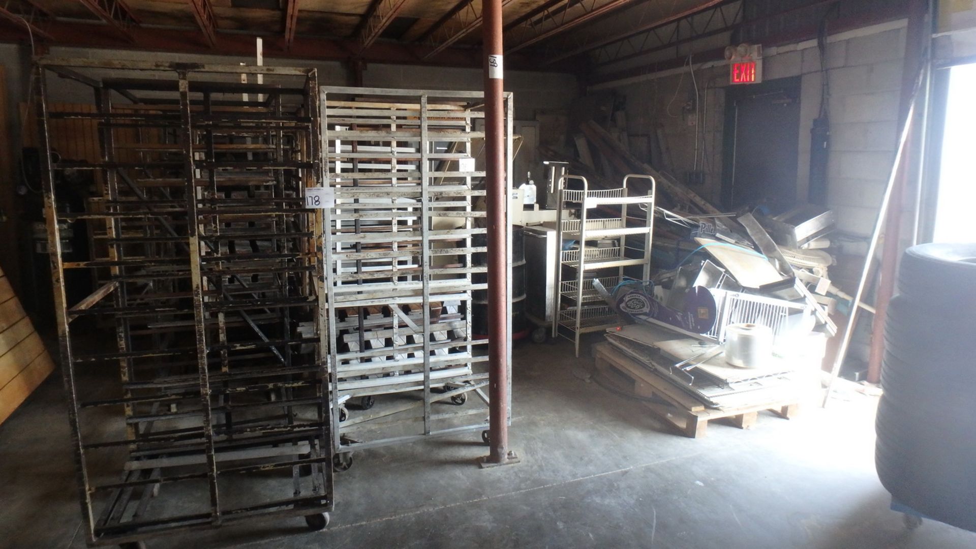 LOT - ASSORTED BAKING TRAY RACKS (AS IS), MACHINE PARTS, SCRAP METAL, ETC (BELOW MEZZANINE & IN