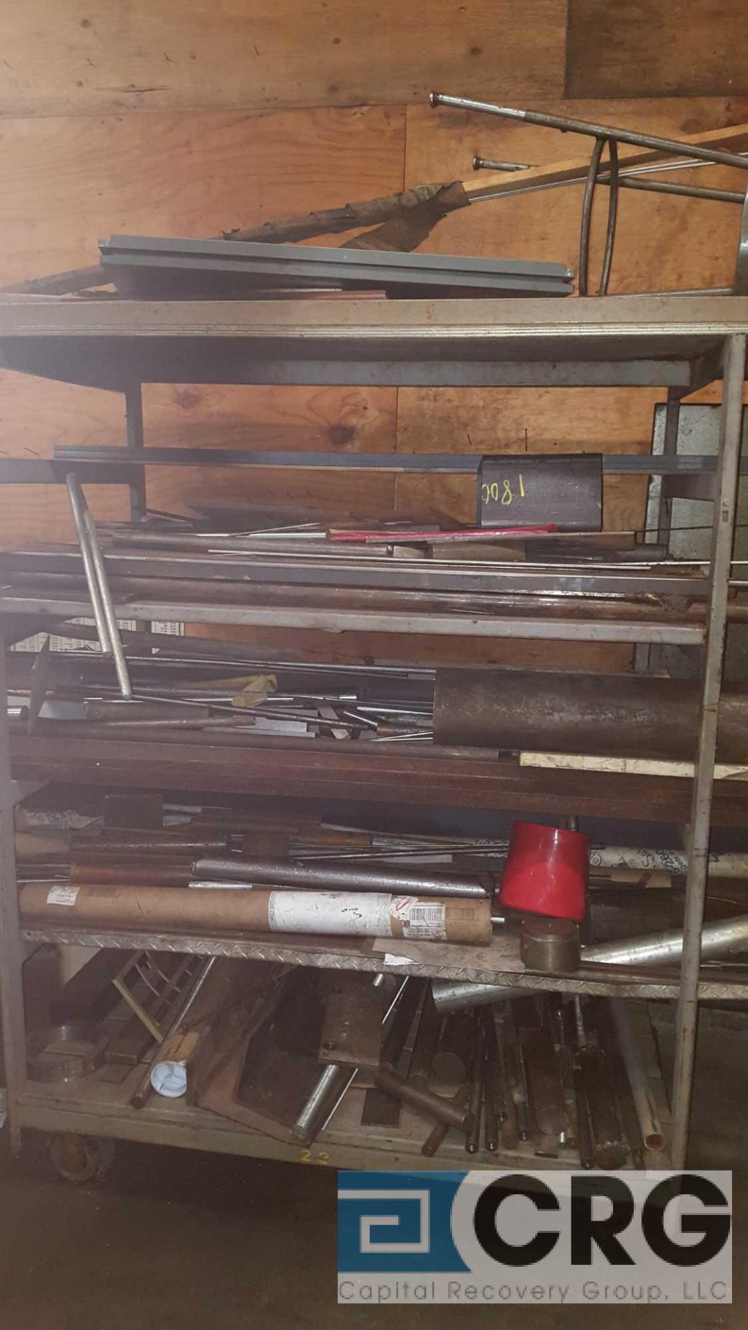 Lot of assorted steel and metal stock contents of the stock rack, stock rack is included.