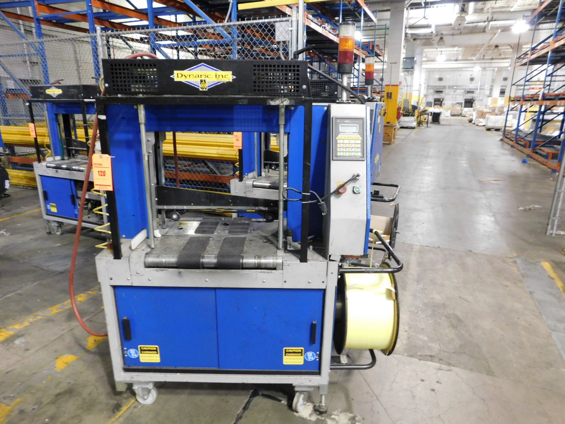 Dynark banding machine with discharge roller conveyor, 5 ft. long by 18 in. wide, mobile, asset #