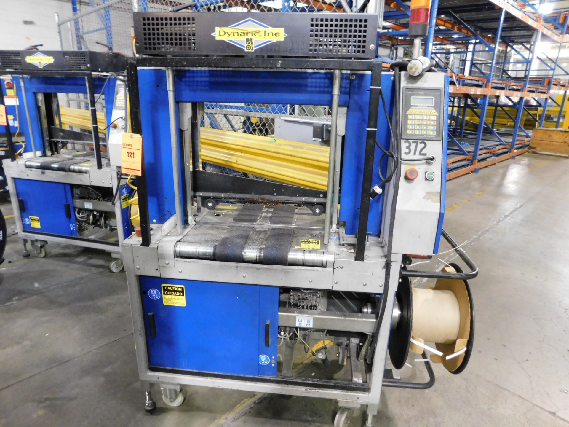 2000 Dynark banding machine with discharge roller conveyor, 5 ft. long by 18 in. wide, asset #