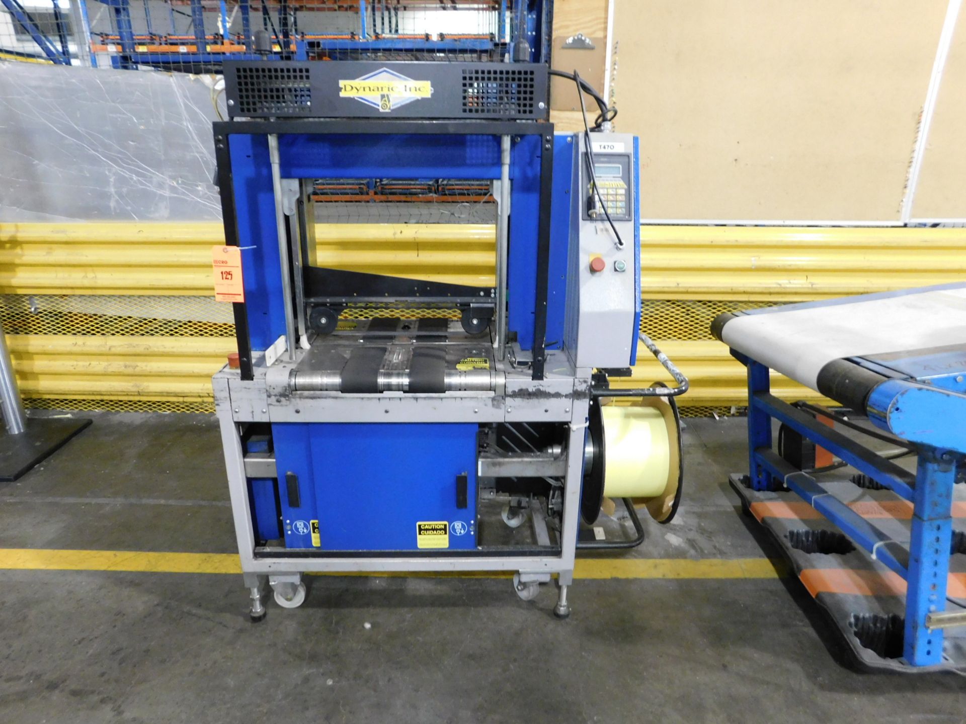2000 Dynark banding machine with discharge roller conveyor, 5 ft. long by 18 in. wide, asset # T470,