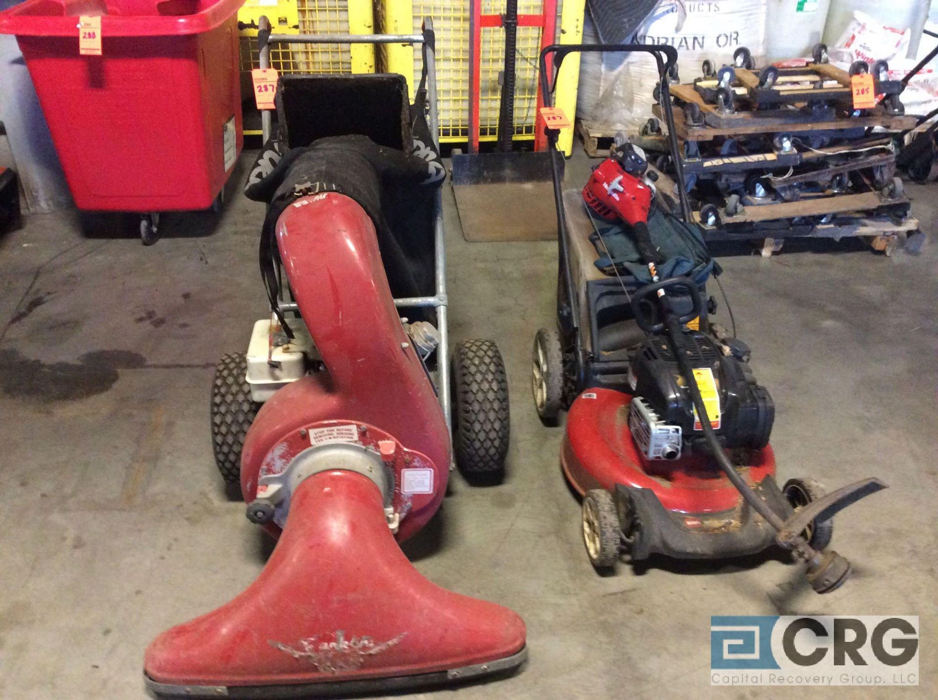 Lot of landscape items including walk behind mower, weed eater, and walk behind leaf vac