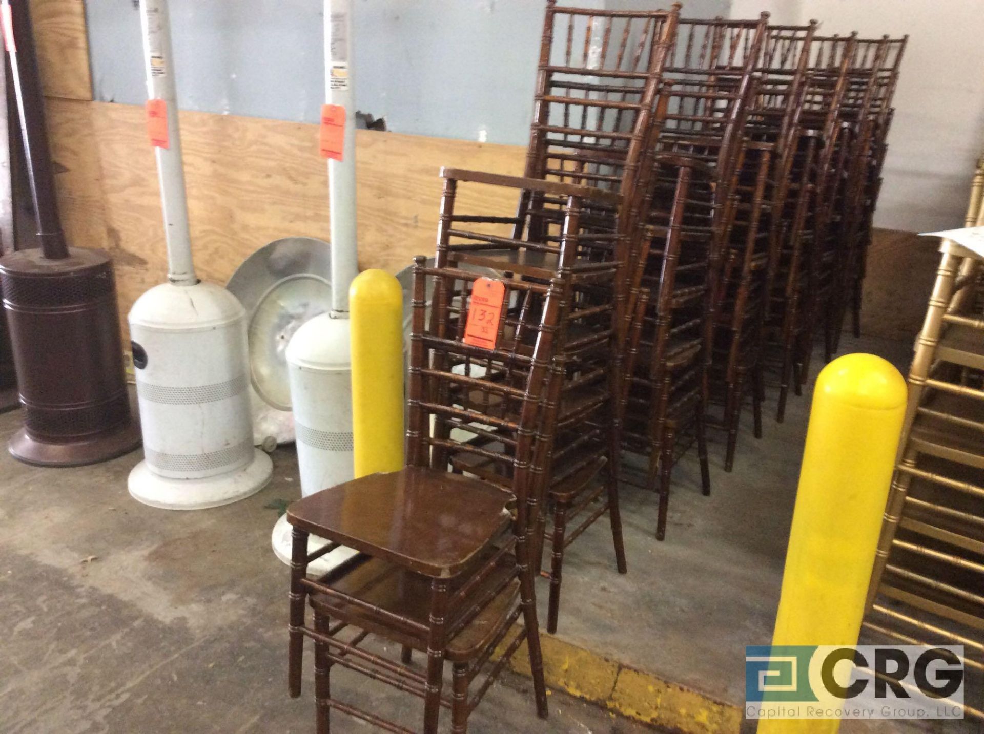 Lot of (32) dark natural wood chivari chairs.