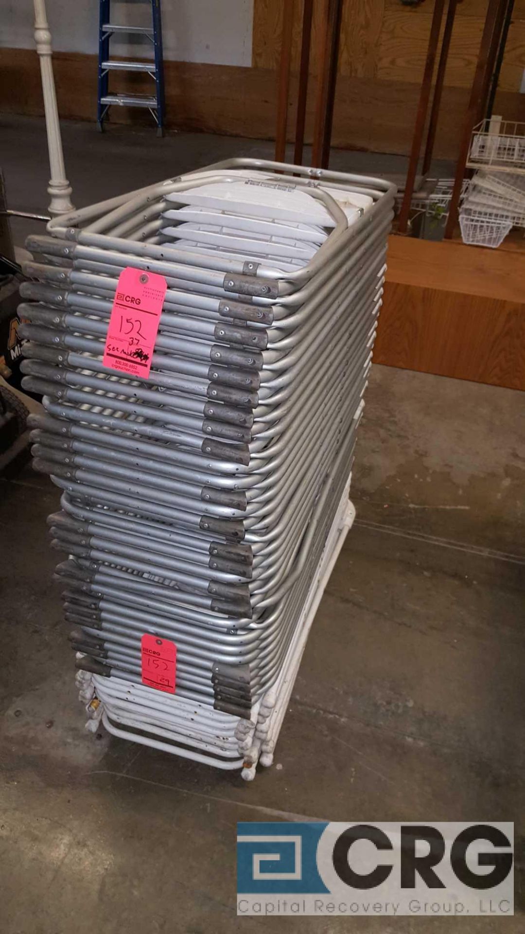Lot of (37) assorted white metal frame with plastic seat folding chairs.