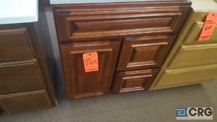 Wood vanity, 22 in x 23 1/2 in, with (2) drawers and (1) door.