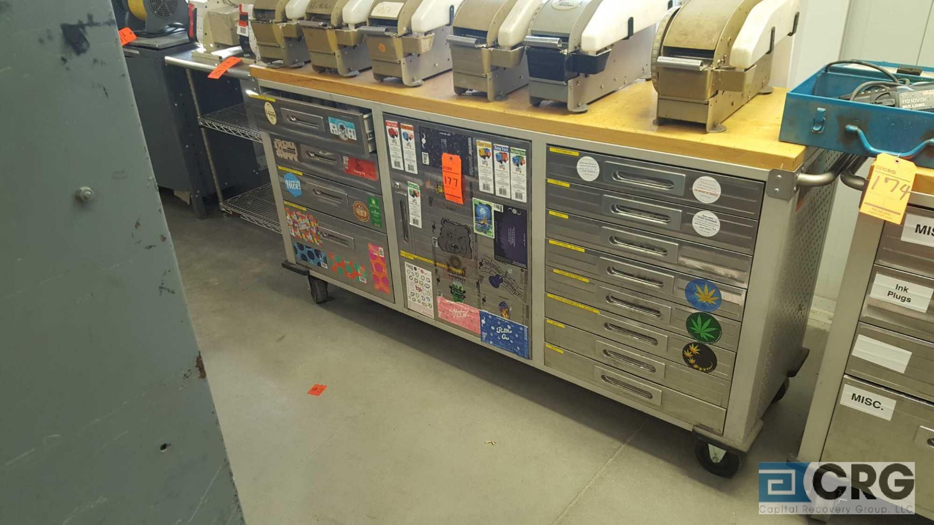 Stainless Steel rolling printers cabinet, (11) drawers, (1) door center cabinet, and butcher block