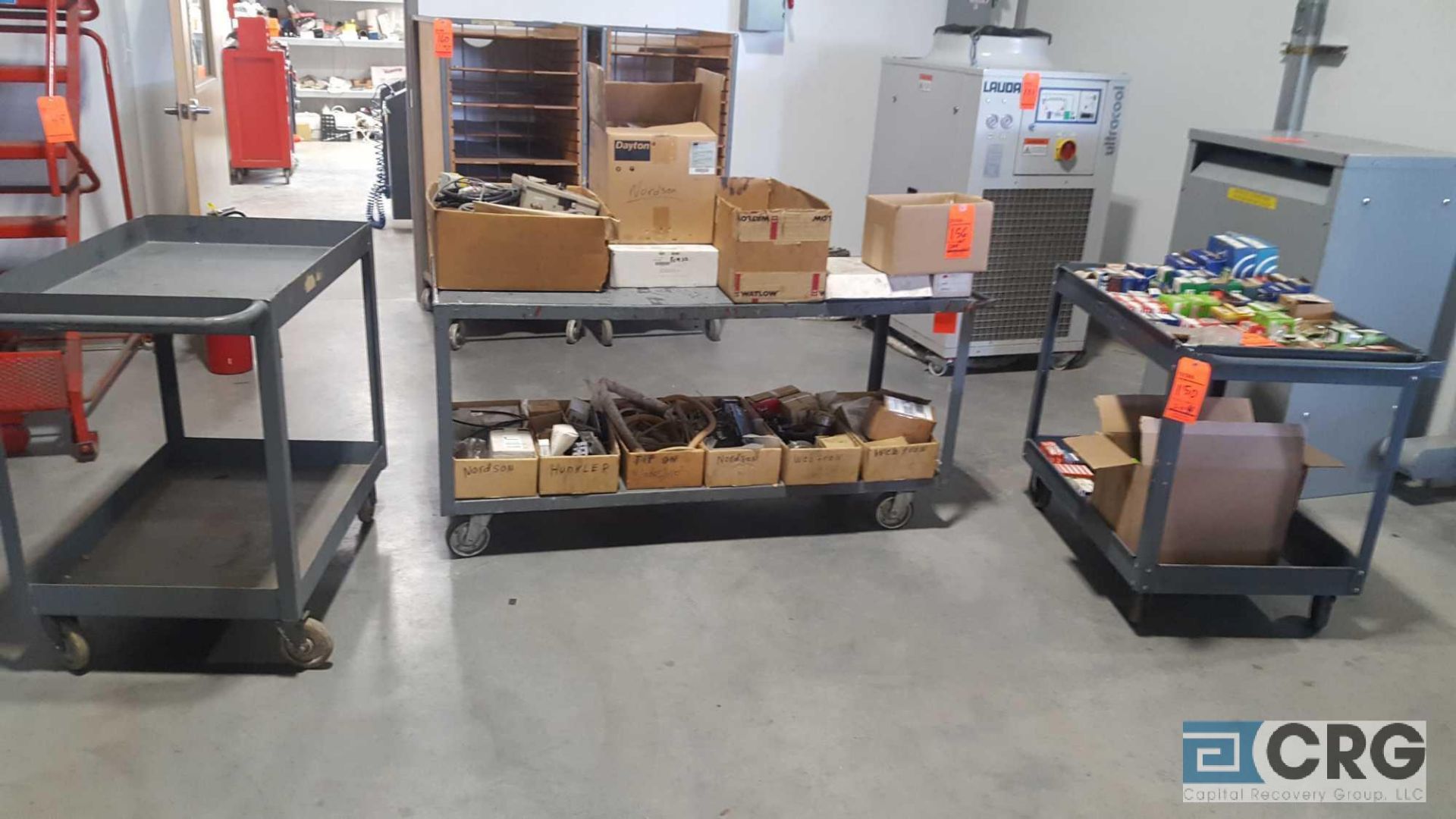 Lot of (4) assorted metal shop carts no contents