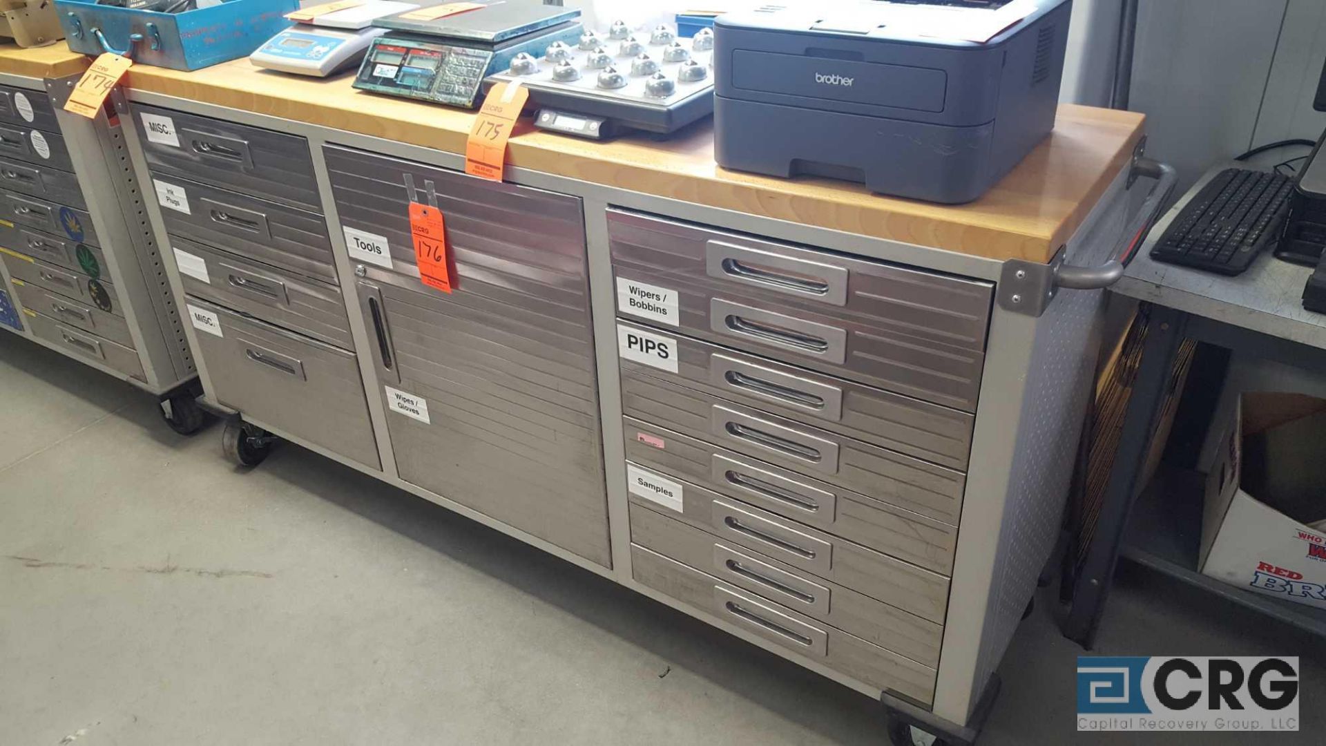 Stainless Steel rolling printers cabinet, (11) drawers, (1) door center cabinet and butcher block