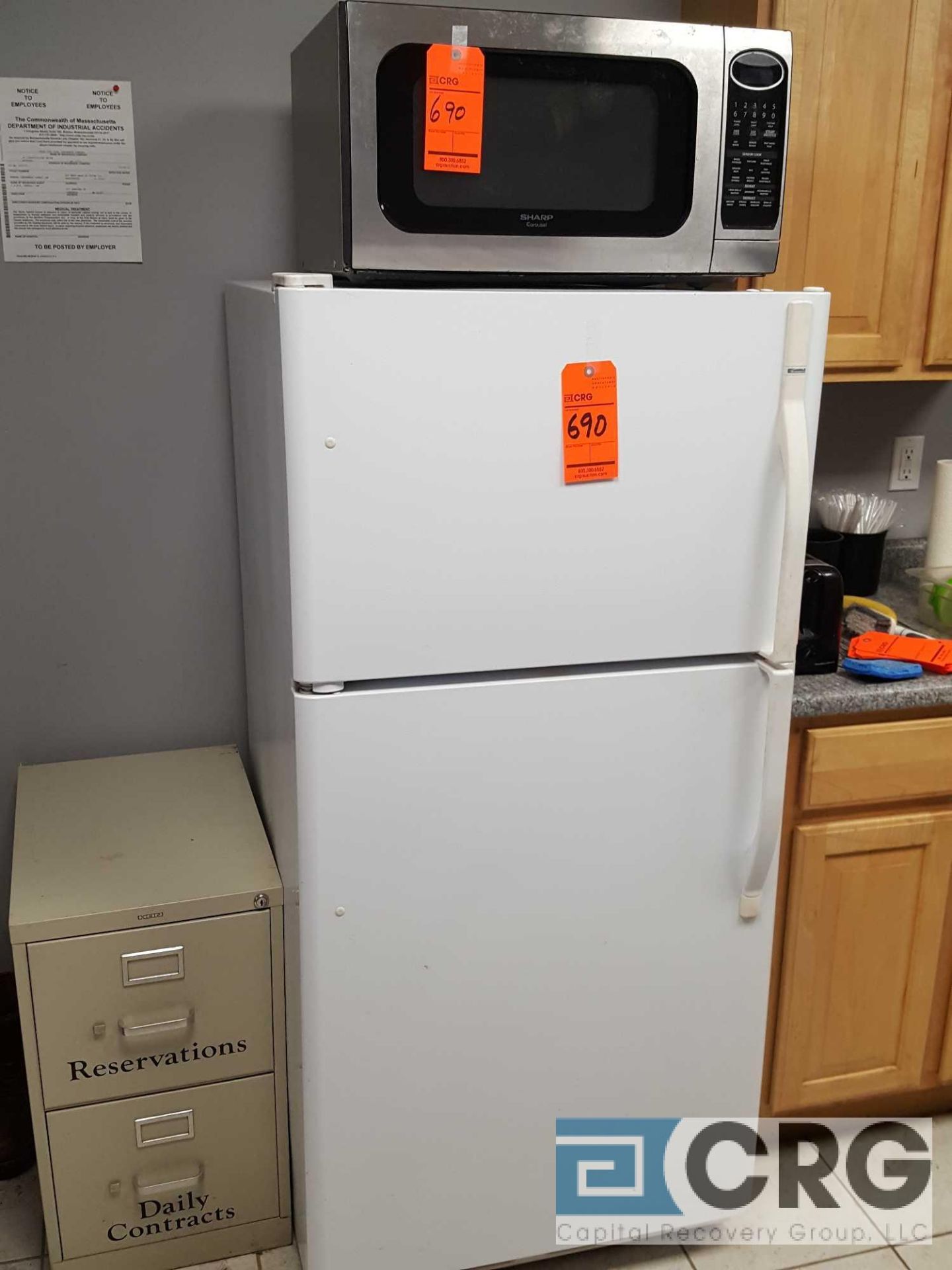 Lot includes Sharp SS digital microwave and Kenmore upright refrigerator/freezer.