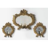 MANIFATTURA ITALIANA DEL XVIII SECOLO Group of three carved and gilded mirrors with leafy motif.