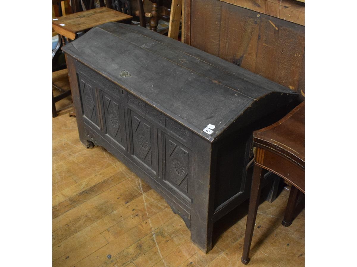 A 19th century oak coffer, the shaped top above a carved four panel front, 124 cm wide