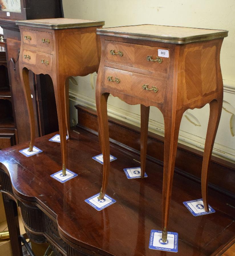 A pair of Louis XVI style kingwood bedside chests, the marble tops above two frieze drawers, on